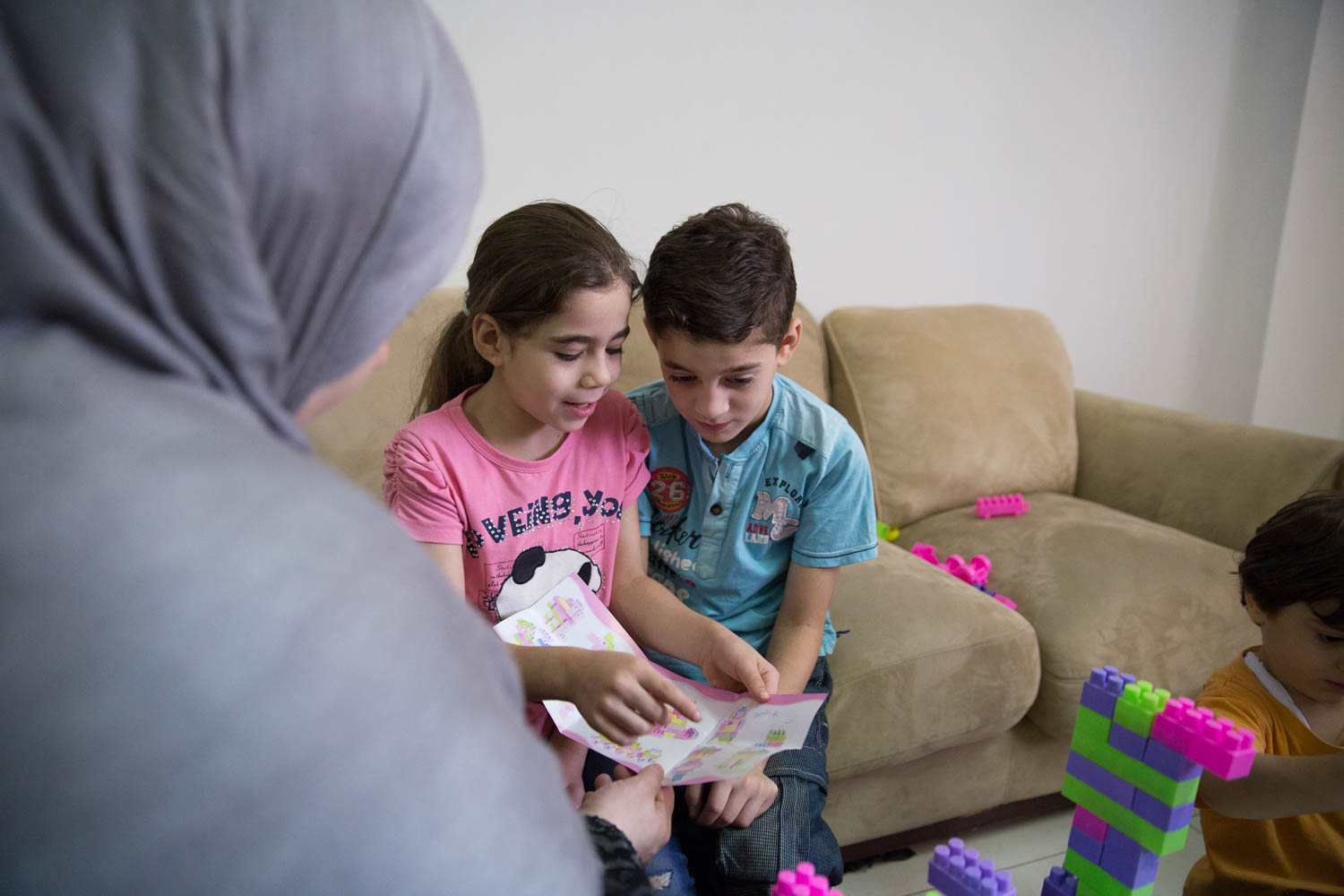  Amaal, 31, watches her children play together. Especially her oldest son Ahmed, 9, suffers from trauma from what their family has experienced fleeing the war in Syria. Even now, 2,5 years after arriving to Egypt, Ahmed is still terrified of the sound of planes, as he imagines they will come to bomb them. His parents have to calm him down reminding him "We are in Egypt now, we are safe." He also has difficulties sleeping, as he still demands his father to lay next to him and stay awake while he sleeps. Ahmed's parents hope for psychological support to help their son recover from this trauma. 