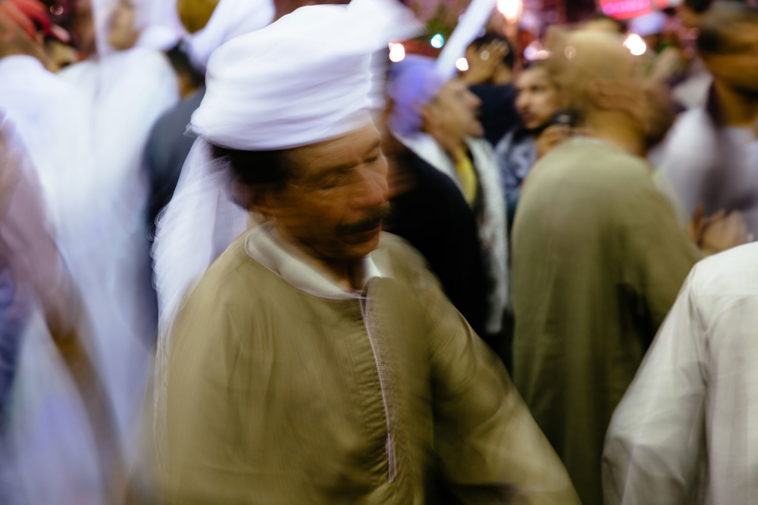  A man sways in a trance to traditional moulid music. Followers of the more spiritual Sufi sect are frequent guests of the festival. They are known to dance and sing for hours into the night. 