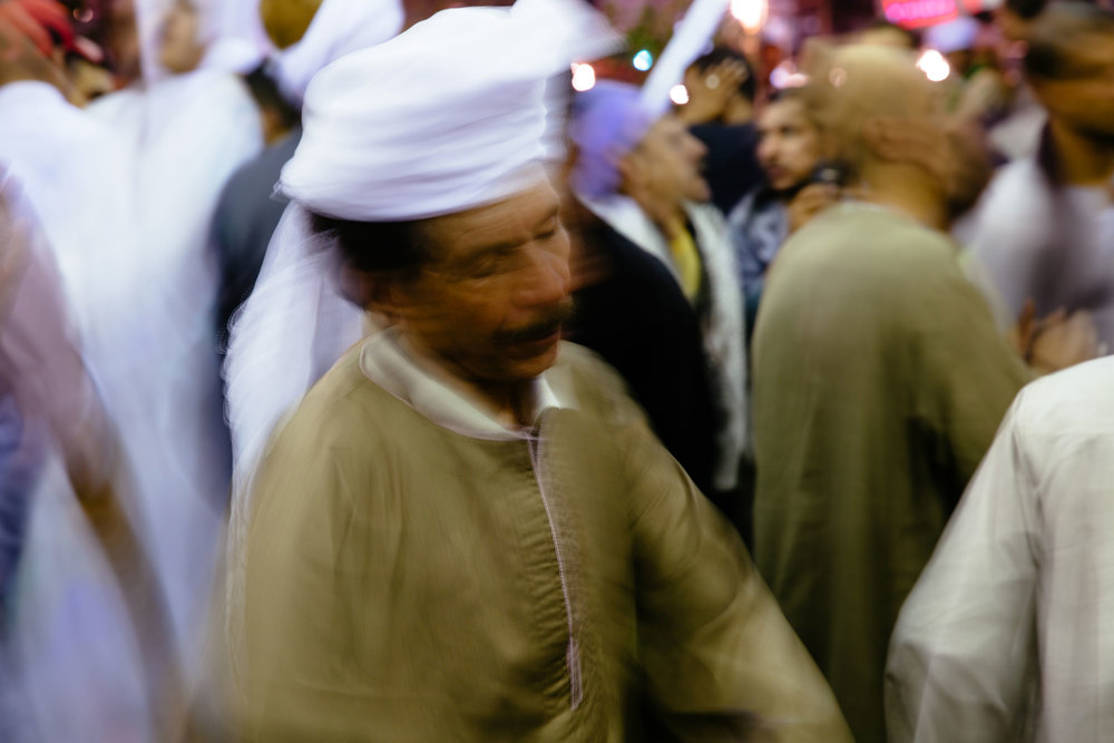 A man sways in a trance to traditional moulid music. Followers of the more spiritual Sufi sect are frequent guests of the festival. They are known to dance and sing for hours into the night.