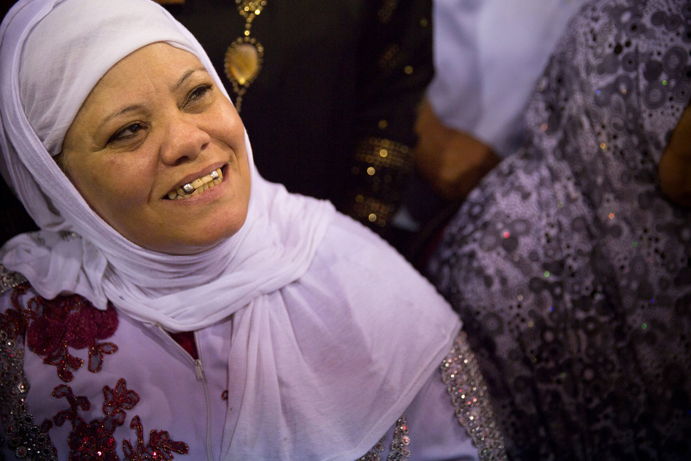 A mother looks upon her daughter singing traditional Sufi music at the Sayeda Zeinab moulid.