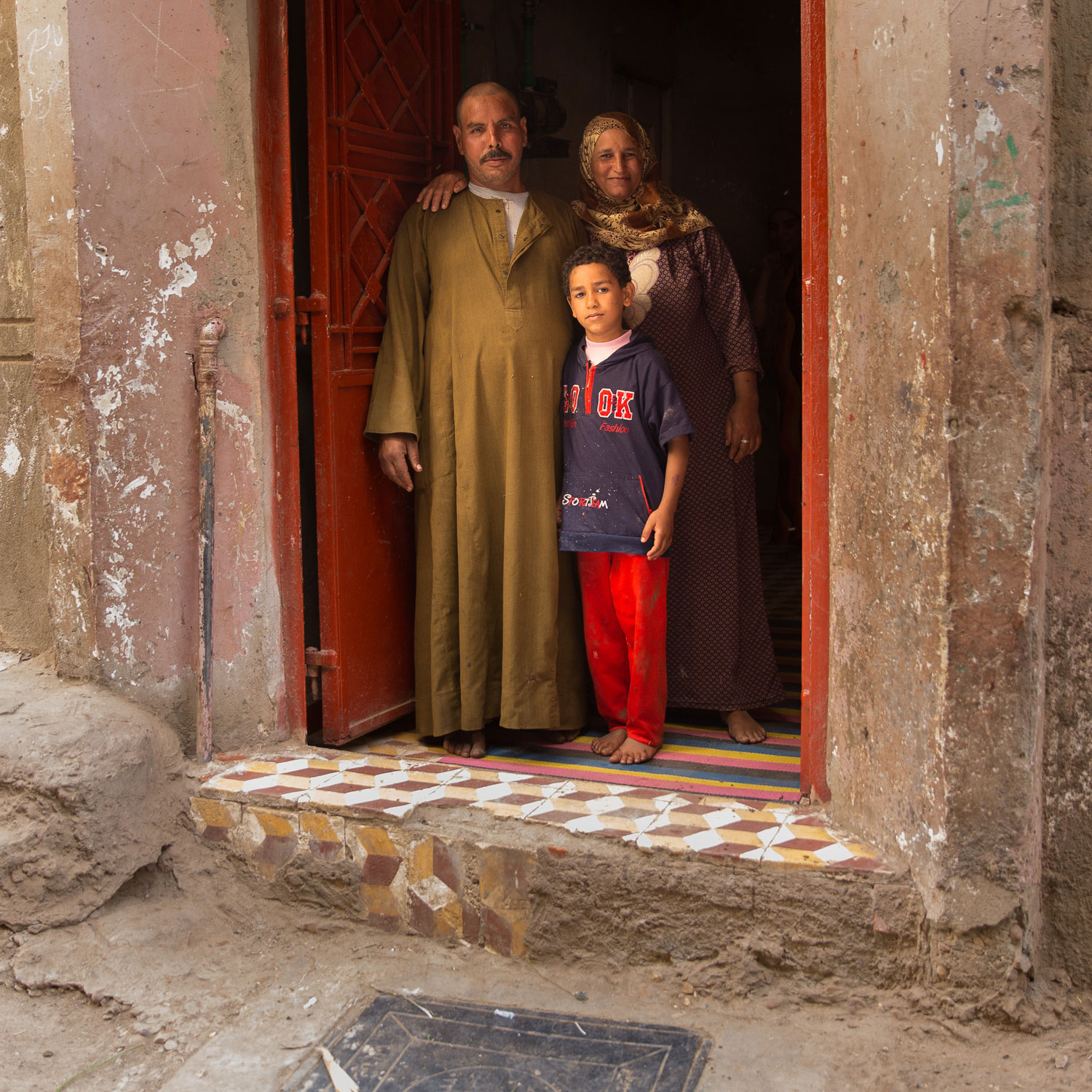  Nada Falwzy and her family have a sewage manhole cover right in front of their home. Before their home had the waste water sanitation connection, they had to rely on the use of a septic tank, which had to be emptied every few weeks. They had a lot of problems including bug bites, roaches and mosquitos.  Now with the sanitation connection, they save money and no longer have to worry about contaminated water in their home.   Photo for USAID/Egypt.  